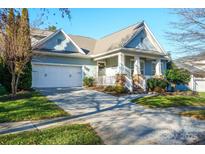 Charming craftsman style home with two-car garage and landscaped lawn at 10439 Donahue Dr, Huntersville, NC 28078