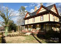 Two-story home with wraparound porch and landscaped yard at 106 N Battleground Ave, Kings Mountain, NC 28086