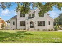 Two-story brick home with a landscaped lawn and inviting front entrance at 669 Dogwood Ln, Davidson, NC 28036