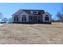 Inviting exterior of new construction home with black shutters, covered porch, and professional design at 2657 Polo Ln, Maiden, NC 28650