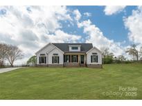 Inviting single-Gathering home with white siding and black shutters, complemented by a lush green lawn at 2657 Polo Ln, Maiden, NC 28650
