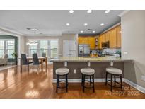Bright eat-in kitchen with granite countertops, stainless appliances and breakfast bar at 18119 Coulter Pkwy, Cornelius, NC 28031