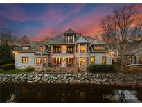 Brick and stone luxury home with water views at sunset at 2310 La Maison Dr, Charlotte, NC 28226