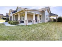 House exterior showcasing a front porch and manicured lawn at 1132 Cades Ct, Denver, NC 28037