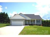 Charming single-story home featuring a two-car garage, well-maintained lawn and inviting front porch at 118 Cypress Acres Ln, Statesville, NC 28625