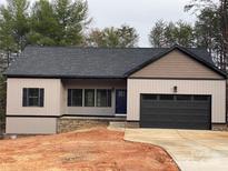 Charming single-story home with a two-car garage, neutral siding, and well-maintained landscaping at 5743 Selkirk Dr, Hickory, NC 28601