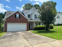 Charming two-story home with a brick facade, attached two car garage, and a well-manicured lawn at 9903 Southampton Commons Dr, Charlotte, NC 28277