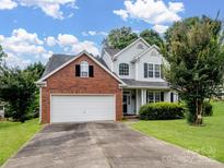 Charming two-story home with a brick front, attached garage, and well-maintained lawn at 9903 Southampton Commons Dr, Charlotte, NC 28277