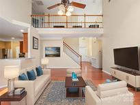 Spacious living room with high ceilings, hardwood floors, and modern furnishings, perfect for entertaining and Gathering gatherings at 9903 Southampton Commons Dr, Charlotte, NC 28277