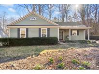 Charming ranch home with gray siding, shutters, and a covered porch at 1511 Longbrook Dr, Charlotte, NC 28270