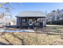 Cute one-story home with front porch and large yard at 247 Camp Rotary Rd, Gastonia, NC 28052