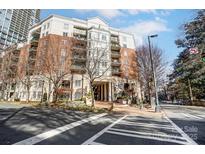 Beautiful multi-story building featuring balconies, brick accents, and manicured landscaping at 300 W 5Th St # 339, Charlotte, NC 28202