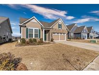 Brick ranch home with 2-car garage, green door, and manicured lawn at 9023 Daring Ct, Charlotte, NC 28215