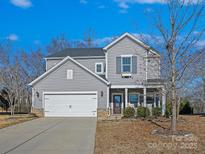 Two-story gray house with white garage door and landscaping at 3001 Cedric Ct, Fort Mill, SC 29715