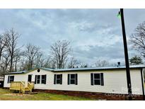 Single-wide manufactured home with a new metal roof and deck at 568 Mahaffey Dr, Salisbury, NC 28146