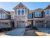 Two-story townhome with stone accents and a two-car garage at 810 Ayrshire Ave, Fort Mill, SC 29708