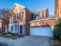 Brick front exterior of charming townhome with attached garage at 9182 Bonnie Briar Cir, Charlotte, NC 28277