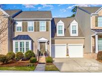 Tan two-story house with two-car garage and landscaped front yard at 14839 Rocky Top Dr, Huntersville, NC 28078