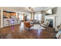 Open living room featuring hardwood floors, fireplace, and ample natural light at 2229 Iron Works Dr, Clover, SC 29710