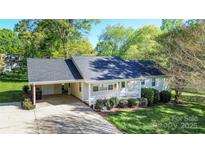 Charming single-story home featuring a welcoming front porch and a convenient carport at 3309 E Broad St, Statesville, NC 28625