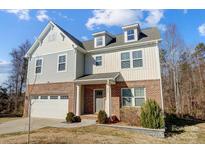 Two-story brick home with gray siding, white garage door, and landscaping at 356 Nantucket Way, Rock Hill, SC 29732