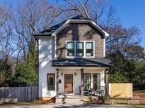 Two-story house with gray and white siding, a front porch, and a landscaped yard at 1019 Trembeth Dr, Charlotte, NC 28205