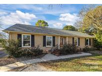 Brick ranch home with a landscaped yard and attached garage at 2008 Townsend Ave, Charlotte, NC 28205