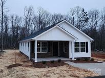 Newly constructed home with brick and vinyl siding, covered porch, and landscaping at 301 Cornelius Dr, Rock Hill, SC 29730