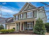 Charming two-story home with a welcoming front porch and meticulously manicured landscaping, enhancing its curb appeal at 17611 Austins Creek Dr, Charlotte, NC 28278