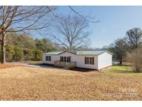 White single-wide mobile home with green metal roof; large yard at 2379 Justin Dr, York, SC 29745