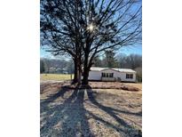 Single-wide mobile home with large yard and mature trees at 2379 Justin Dr, York, SC 29745