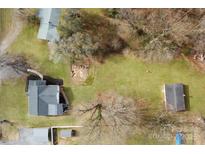 Aerial view of the home with a large yard, fire pit, shed, and detached garage at 364 Scotts Creek Rd, Statesville, NC 28625