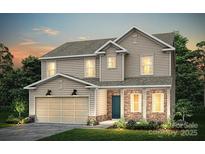 Charming two-story home featuring a two-car garage, stone accents and manicured lawn at 5215 Hatcher Creek Rd # 40, Charlotte, NC 28215