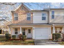 Two-story townhome with neutral siding, attached garage, and small front porch at 5927 Pisgah Way, Charlotte, NC 28217
