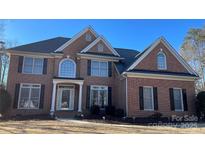 Brick front two-story house with a large yard at 2306 Cota Ct, Charlotte, NC 28262