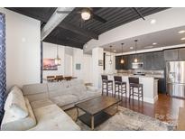 Open concept kitchen with breakfast bar and stainless steel appliances at 2338 Yadkin Ave # 505, Charlotte, NC 28205