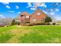 Stately brick home with manicured lawn, mature landscaping, and inviting front entrance at 2510 Burton Estates Ln, Lincolnton, NC 28092