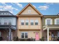 Tan townhome with pink door, charming landscaping, and welcoming exterior at 684 Dunkins Ferry Rd, Rock Hill, SC 29730