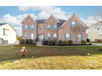 Brick two-story house with landscaping and a front yard at 1009 Murandy Ln, Matthews, NC 28104