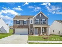 Brick two-story house with gray accents and a two-car garage at 1423 Pine Heart Dr, Edgemoor, SC 29712