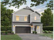 Two-story house with gray siding, dark garage door, and landscaping at 3024 Sadler Woods Ln, Charlotte, NC 28214