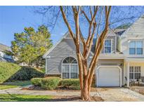 Gray siding townhouse with a white garage door and landscaping at 6078 Bobcat Pl, Charlotte, NC 28269