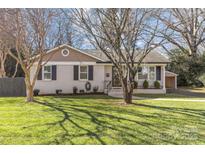 Charming ranch home with brick facade and landscaped lawn at 1814 Archdale Dr, Charlotte, NC 28210