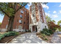 Brick building exterior with landscaping and a paved pathway at 301 W 10Th St # 205, Charlotte, NC 28202