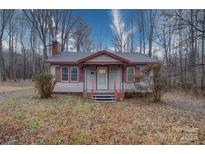 Ranch home with wood siding and a covered porch at 315 W Clairmont St, Troy, NC 27371