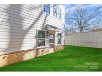 Rear entry townhome with attached garage and small lawn at 3705 Lou Ann Ave, Charlotte, NC 28208