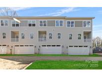 Three-story townhome with attached garage and small yard at 3709 Lou Ann Ave, Charlotte, NC 28208