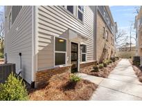 Charming townhome featuring a brick facade, tidy landscaping, and a welcoming entrance at 3717 Lou Ann Ave, Charlotte, NC 28208