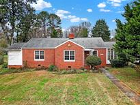 Brick ranch home with a well-manicured lawn at 951 Cedar St, Rock Hill, SC 29730