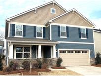 Charming two-story home featuring blue siding, shingle accents, and a two-car garage at 9831 Quercus Ln, Huntersville, NC 28078